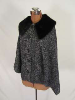 This is a very cute faux fur cape by Cami. It has buttons down the 