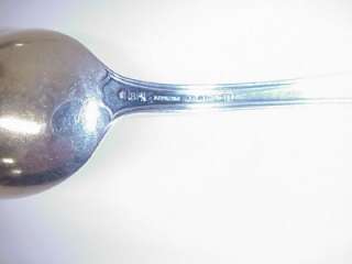 spoon is hallmarked with three cursive letters there are no handling 