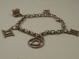 PREOWED TIFFANY CO SILVER CHARM BRACELET. HAS SOME SLIGHT SCRATCHES ON 
