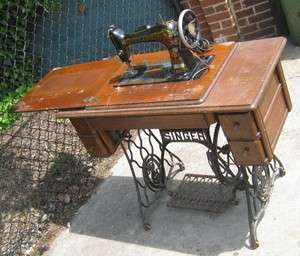 Antique singer sewing machine with wooden cabinet  
