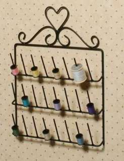 Hangs on your wall to display spools of thread.