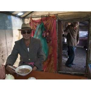  Man in Sunglasses Eats Soup in a Tent at a Nomadic Market 